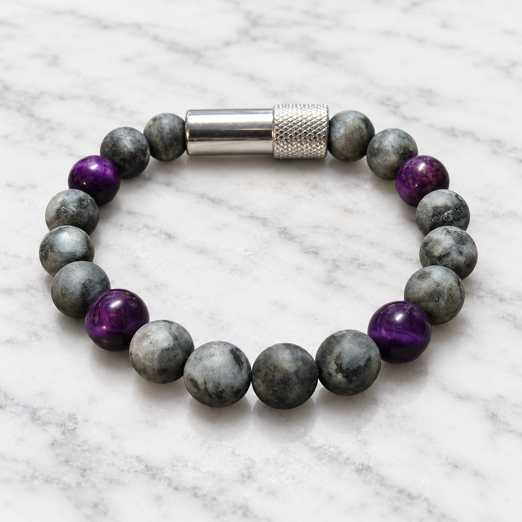 Matte gray Labradorite and purple Tiger’s Eye Embracelet™ with a discreet silver pill holder, displayed on white marble.