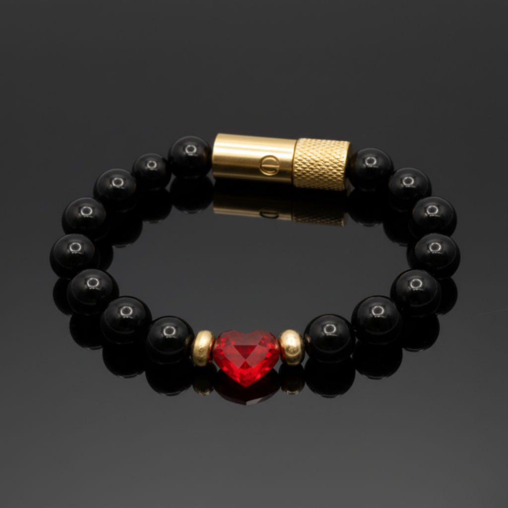 Black beaded bracelet with a red heart-shaped bead and gold clasp on a dark background