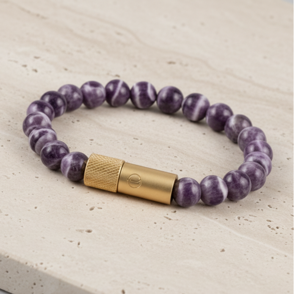 Purple beaded bracelet with a gold clasp on a black background chevron Amethyst wearable pill holder Enusia bracelets 