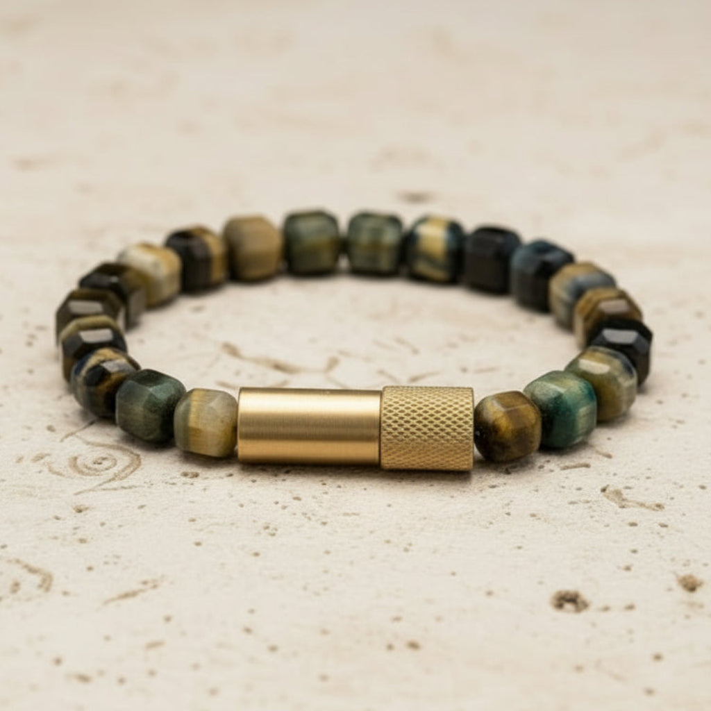 Beaded bracelet with a gold clasp on a textured surface